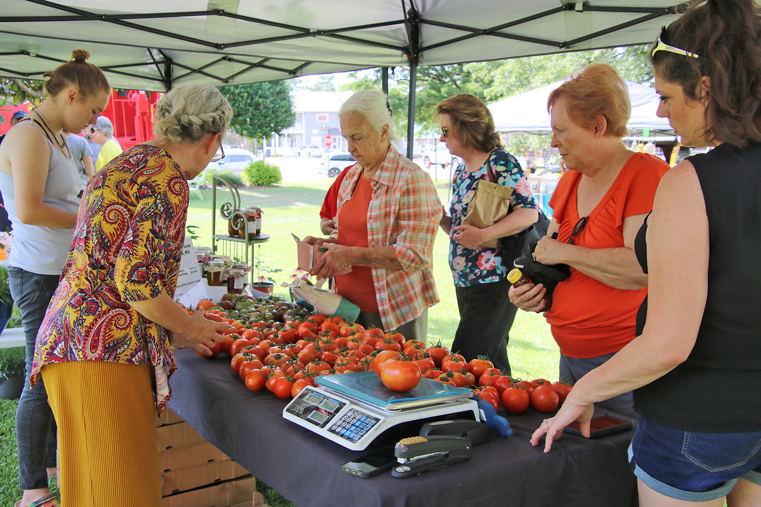 Residents line up to buy tomatoes during the Farmer’s Market in Madison last summer. This year’s season begins on June 6.